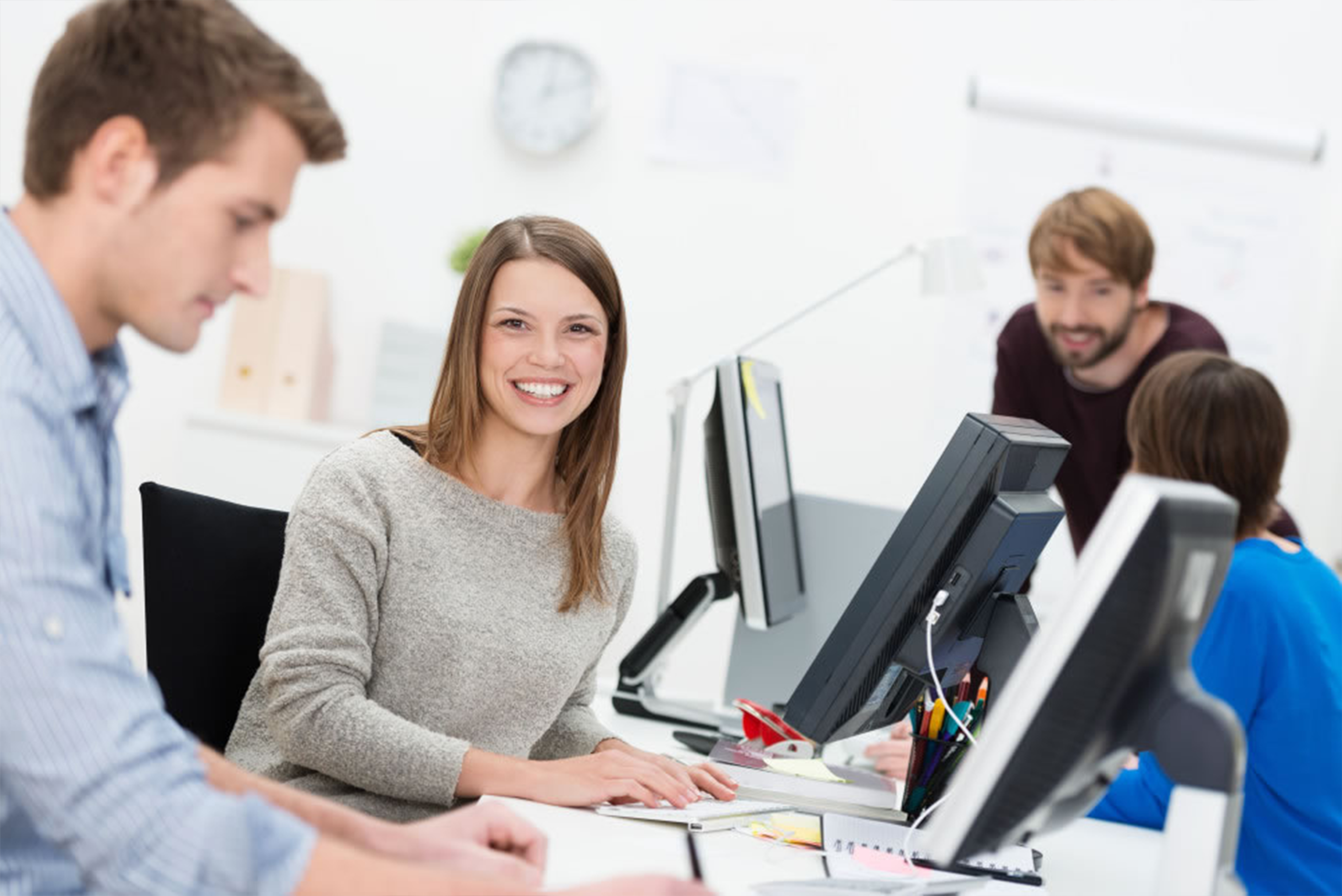 several people sitting in front of computers