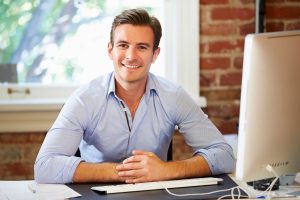 Bussiness Man Sitting at a Desk