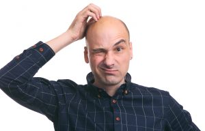 Confused bald guy scratch his head.