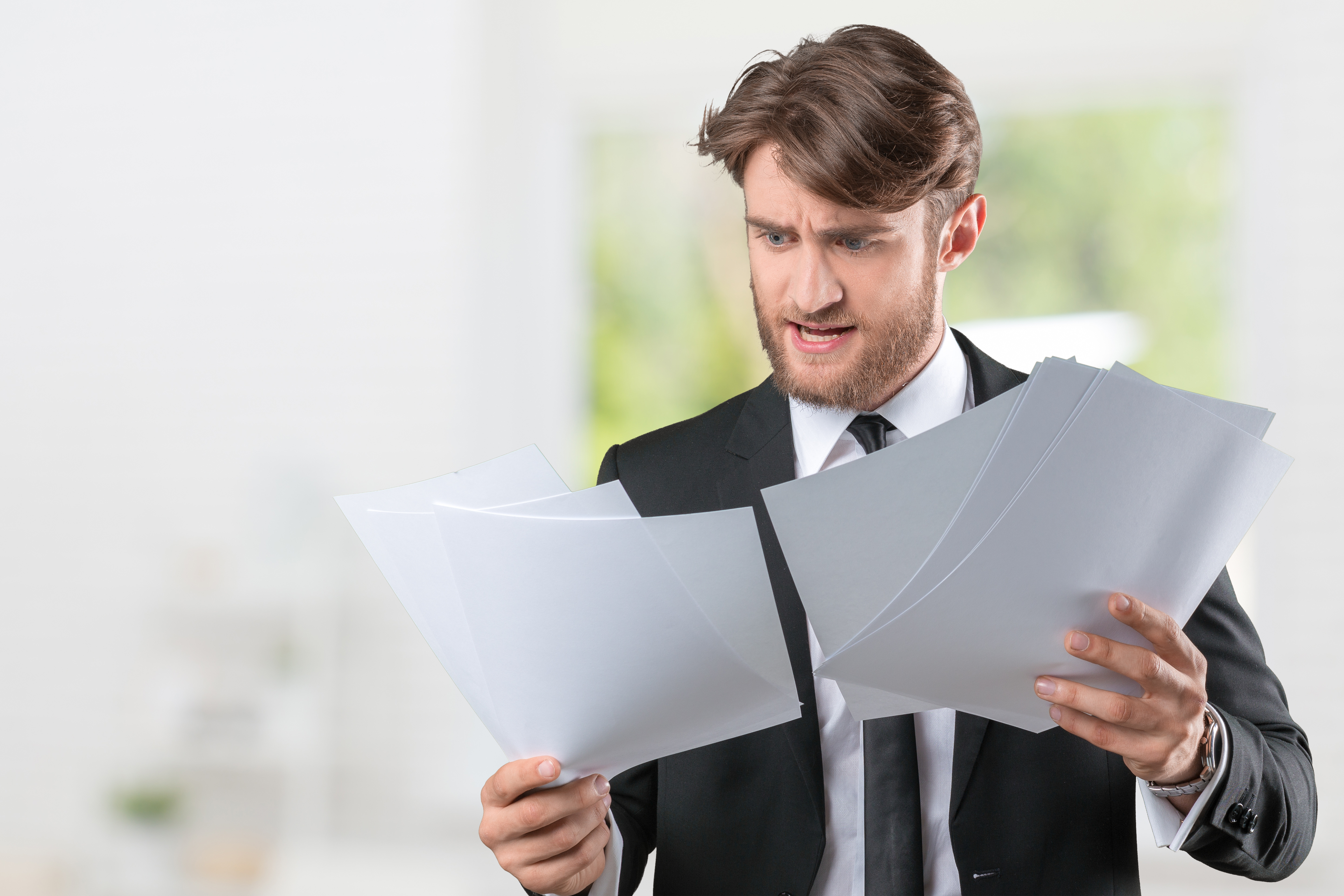 Businessman confused with a lot of paperwork